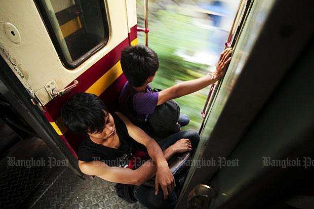 Penumpang kereta kelas ekonomi yang duduk berhadapan dengan toilet yang kotor | Foto: Patipat Janthong (bangkokpost.com)